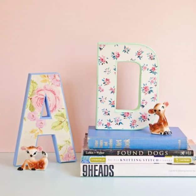 DIY vintage wallpaper letters, a floral papered A and D with mint and blue painted edges propped on a stack of books