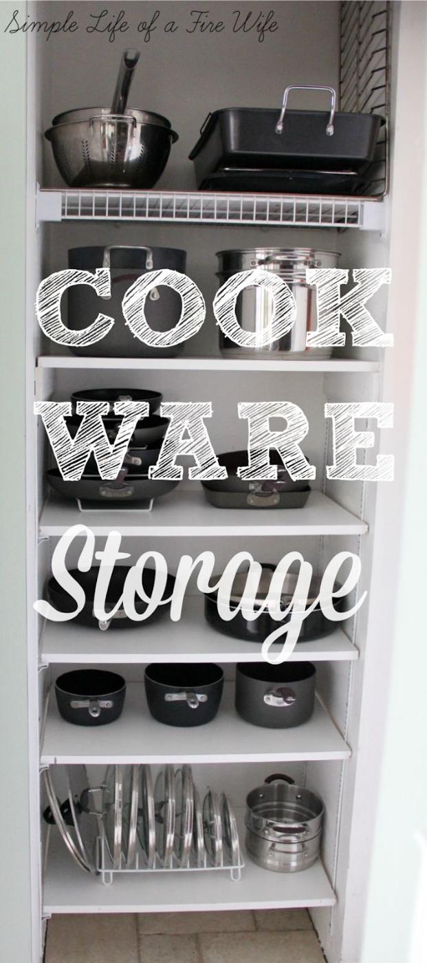 Small pantry closet used for cookware with pans, roasting tins, cake pans and a wire lid rack on white shelves