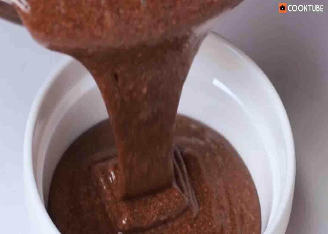 Pouring the chocolate souffle mixture to the ramekin dishes