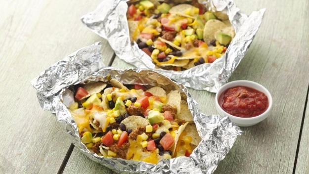 Tex Mex nachos loaded into a foil pack and grilled for a cheesy shareable camping snack or light dinner