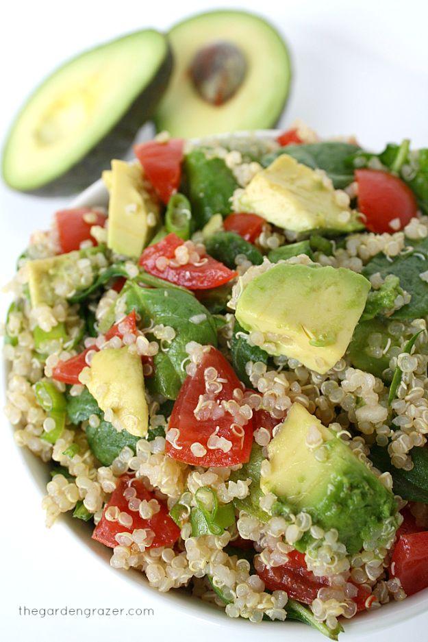 Quinoa avocado spinach power salad with halved grape tomatoes and diced avocado tossed with wilted spinach