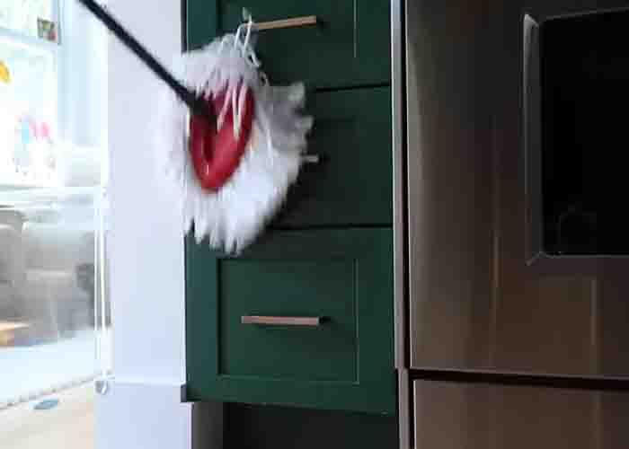 Using spin mop in cleaning kitchen cabinets