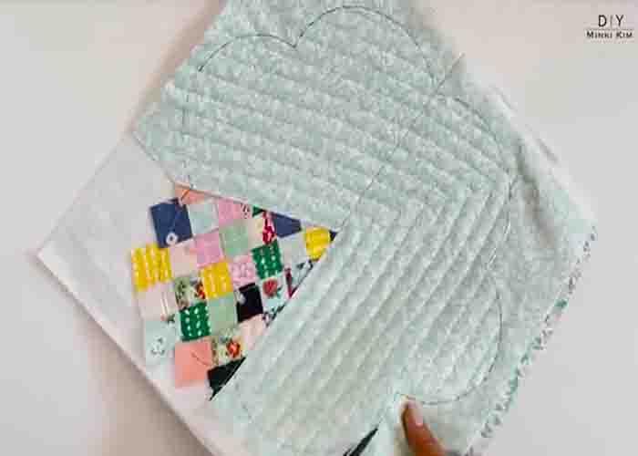 Machine quilting the placemat and shaping it into a flower