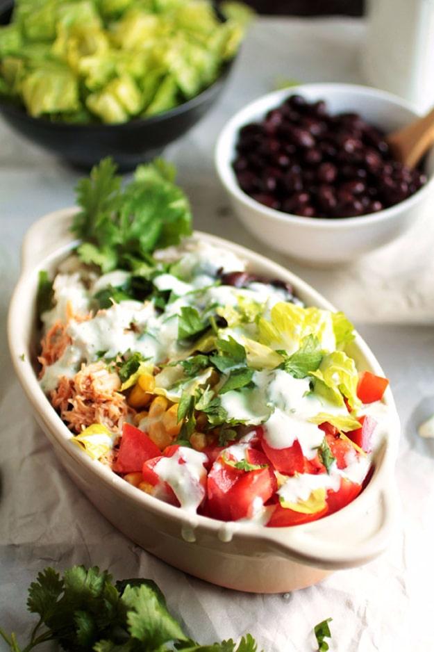Salsa chicken burrito bowls with rice, black beans, corn, romaine and a greek yogurt lime crema drizzle