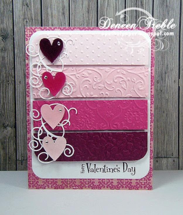 Die cut Valentine's card with embossed paper strips in graduating pinks and glossy hand cut hearts on top