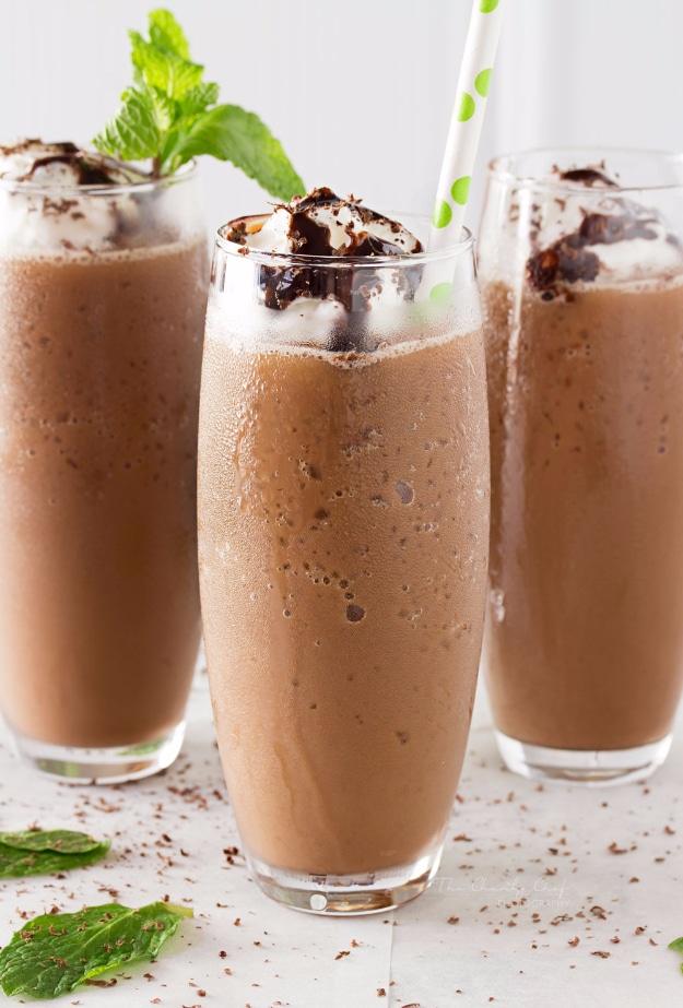 Copycat mocha frappe blended thick in a glass with whipped cream, chocolate drizzle and shaved chocolate