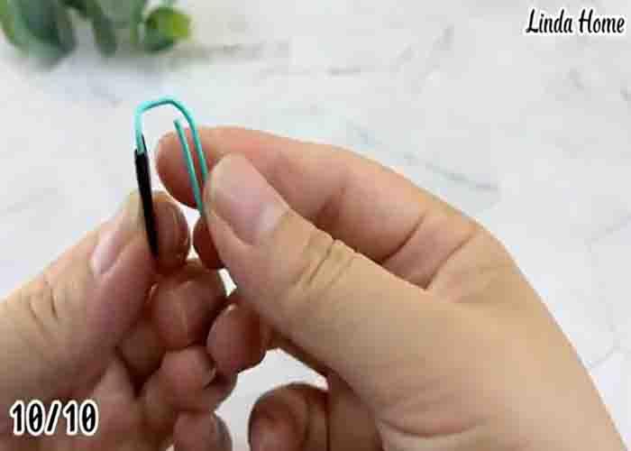 Using a paper clip with an electrical tape to cover the camera of a laptop