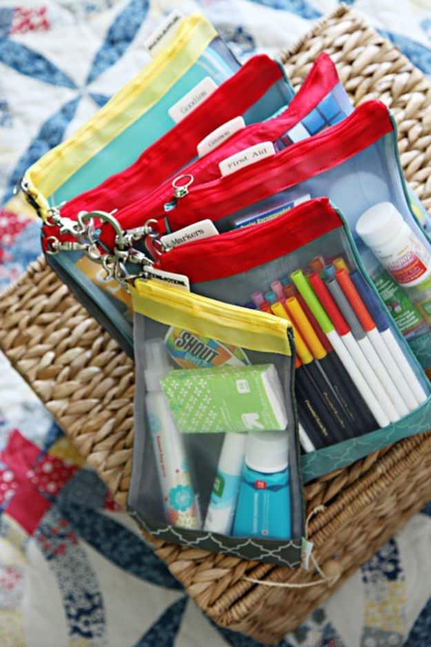 DIY car kit, five mesh zip pouches with red and yellow zips holding first aid, markers and wipes in a woven basket