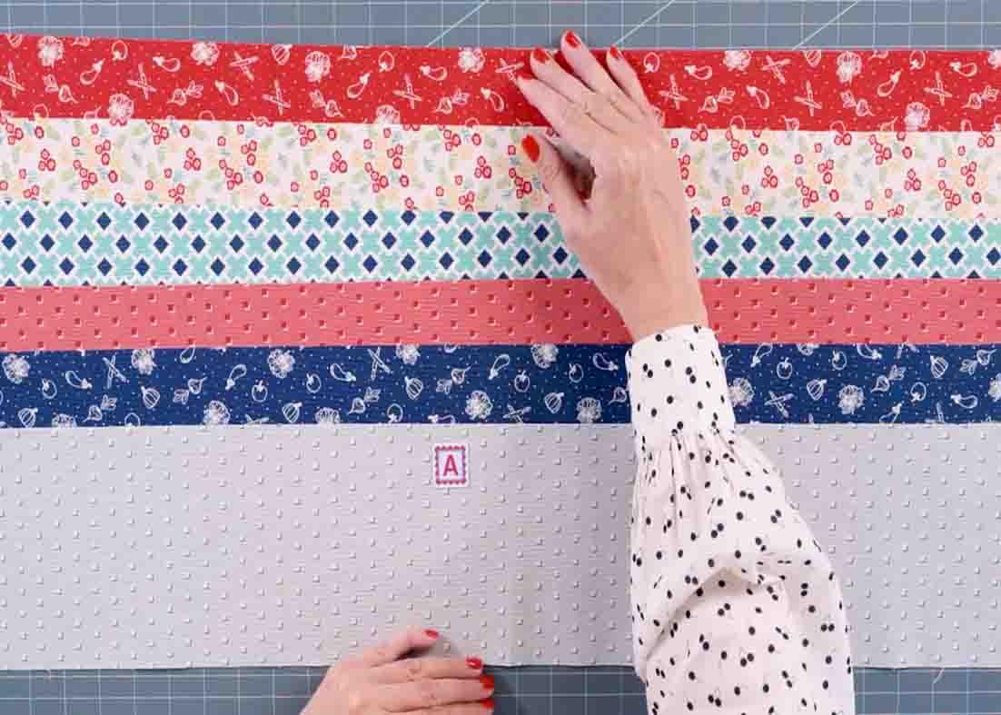 Sewing six strips together to make the half-yard jam quilt