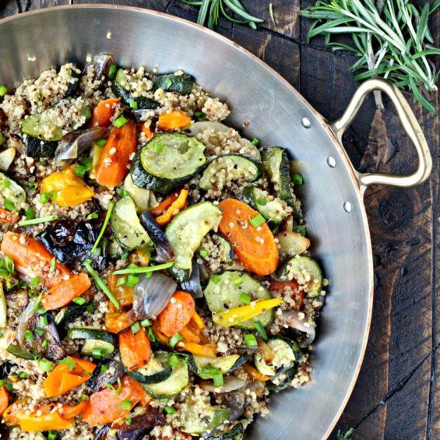Quinoa with roasted vegetables including caramelized zucchini, bell peppers, carrots and red onion in a bowl