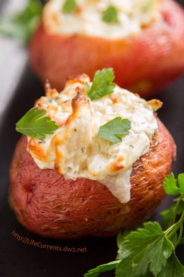 Whole red skinned potato with a creamy crab filling mounded on top and fresh parsley leaves laid over it