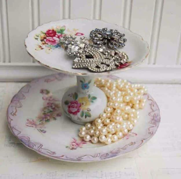 A tiered stand of mismatched floral china plates topped with a gold rimmed teacup, country crafts from vintage finds