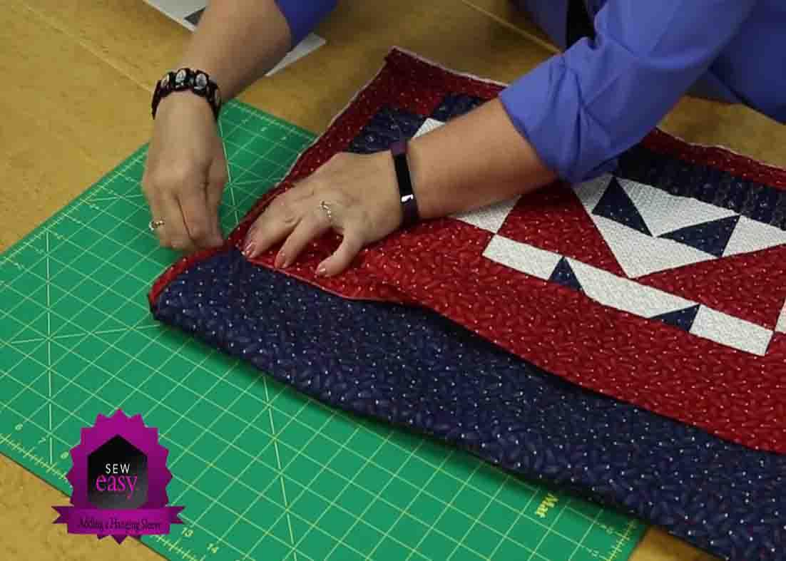 Stitching the hanging sleeve into place