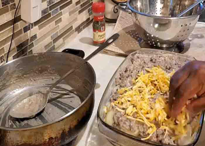 Assembling the cheesy beef and potato casserole