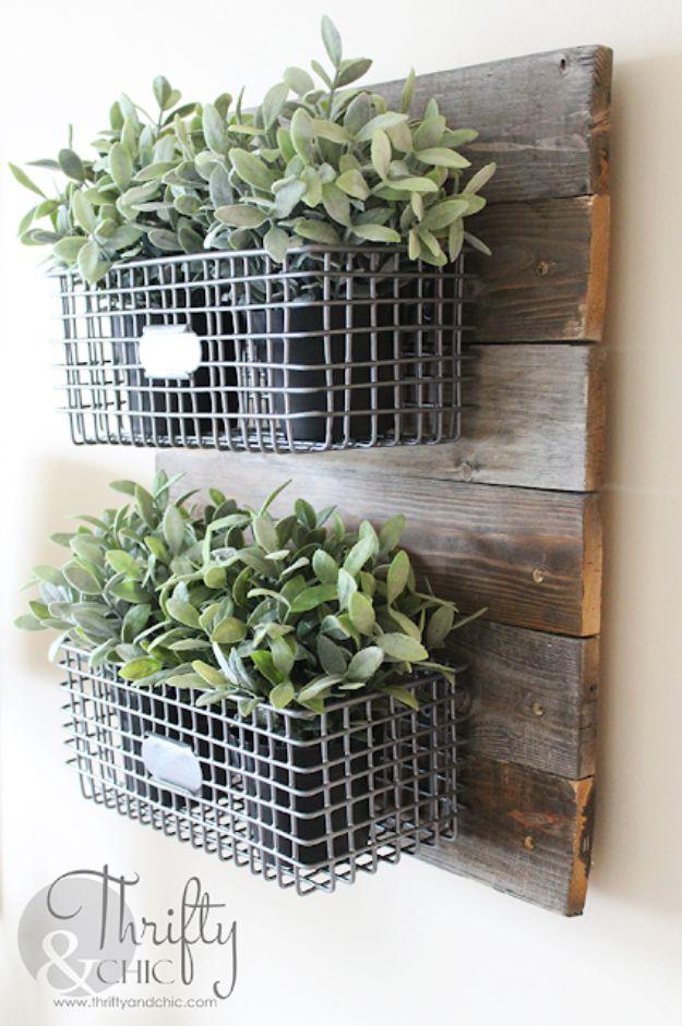 DIY farmhouse hanging wire baskets, two galvanized wire baskets of greenery on a backing of weathered grey slats