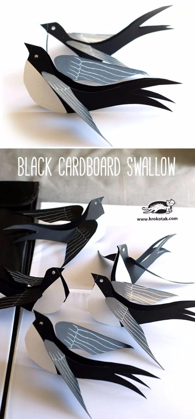 Cardboard craft black swallows with pale grey wings shown in two panels, arranged as if in flight on a white wall