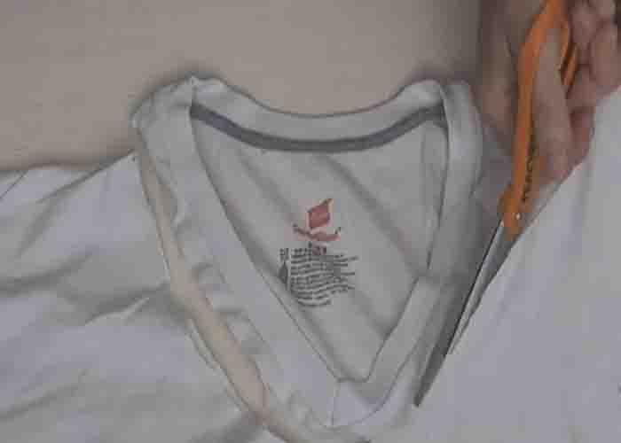 Cutting the neck of the t-shirt to make a DIY tote bag