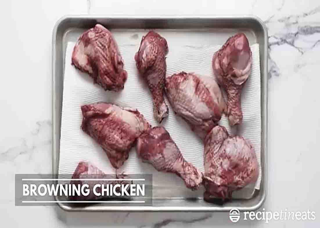 Patting the chicken dry for the french chicken stew recipe