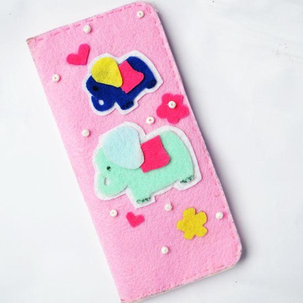 DIY felt wallet, a pink felt wallet decorated with blue and mint elephant appliques, felt flowers and beads