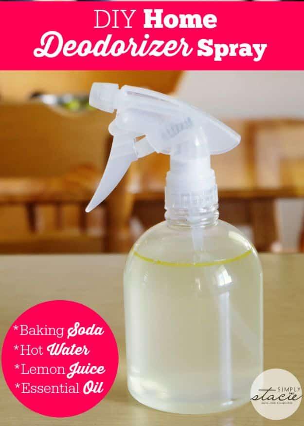 Clear glass spray bottle of home deodorizer with a typeset pink banner listing baking soda, water, lemon and oil