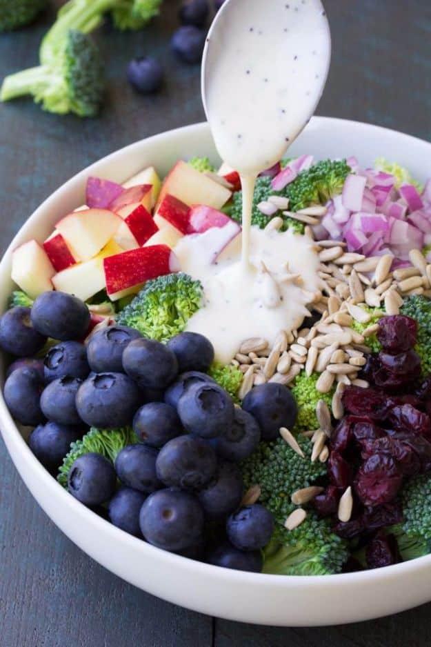 No mayo broccoli salad with blueberries, chopped apple, red onion, cranberries and sunflower seeds in a bowl