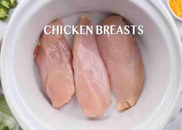 Adding the chicken breasts to the slow cooker
