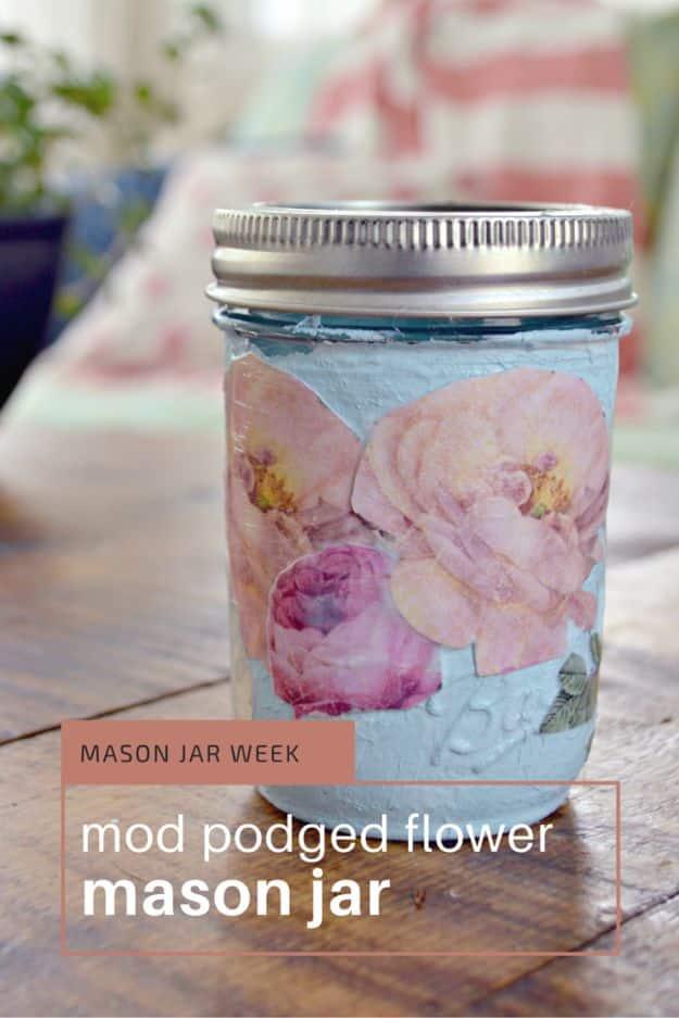 Pin graphic reading mod podged flower mason jar showing a pale blue jar decoupaged with pink paper flowers