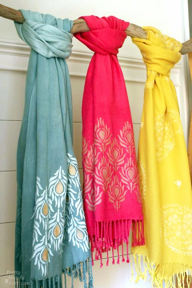 A stenciled and dyed scarf in blue and cream draped over a shoulder, every run slightly different, Etsy crafts