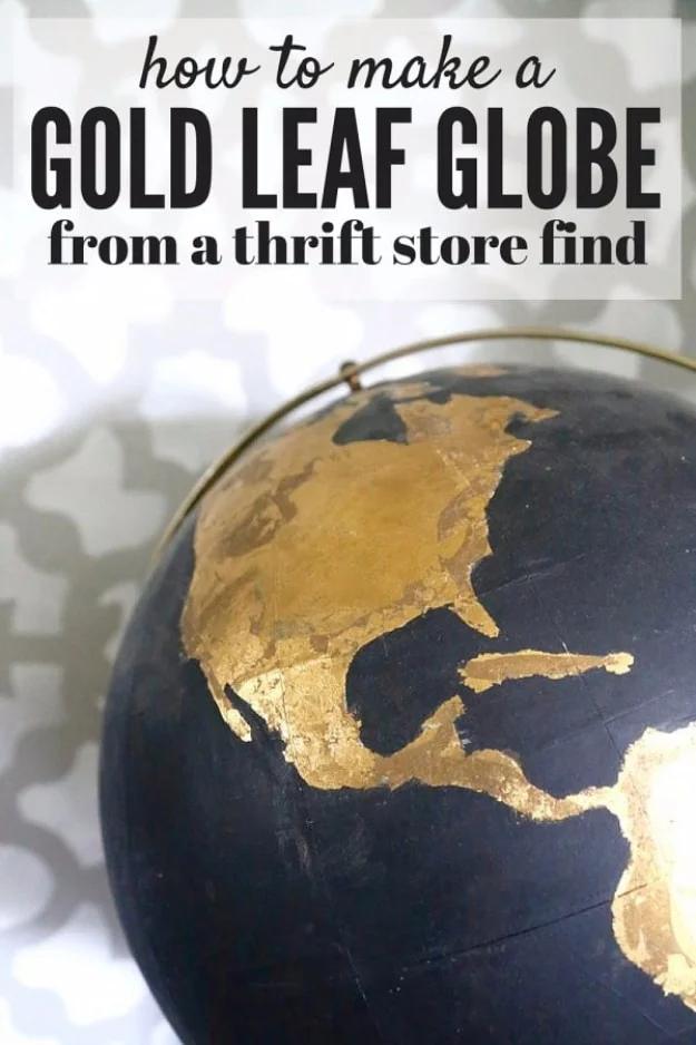 DIY black and gold globe, a thrift store globe with black painted oceans and gold leaf continents against a patterned wall