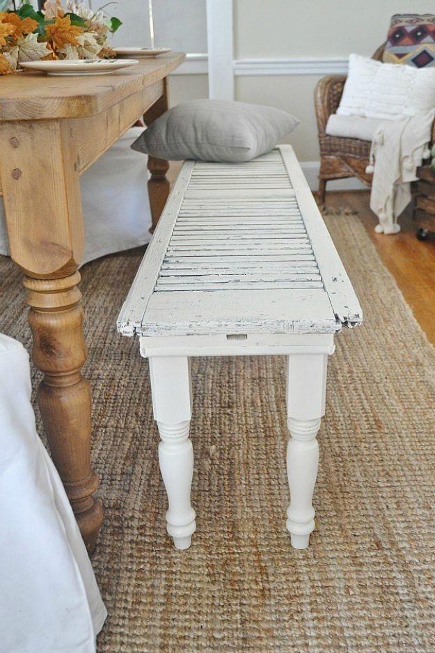 DIY rustic shutter bench, a chippy white louvred shutter laid flat on four turned white legs on a jute rug