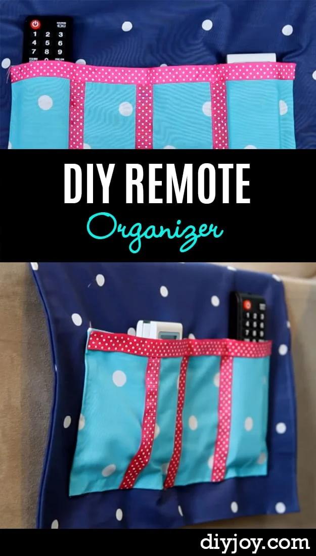 A quilted navy print remote caddy draped over a sofa arm, its row of deep pockets holding three remotes and a notepad.