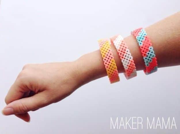 Perler bead bracelet, three beaded bangles in coral white and teal diamond patterns worn on a forearm