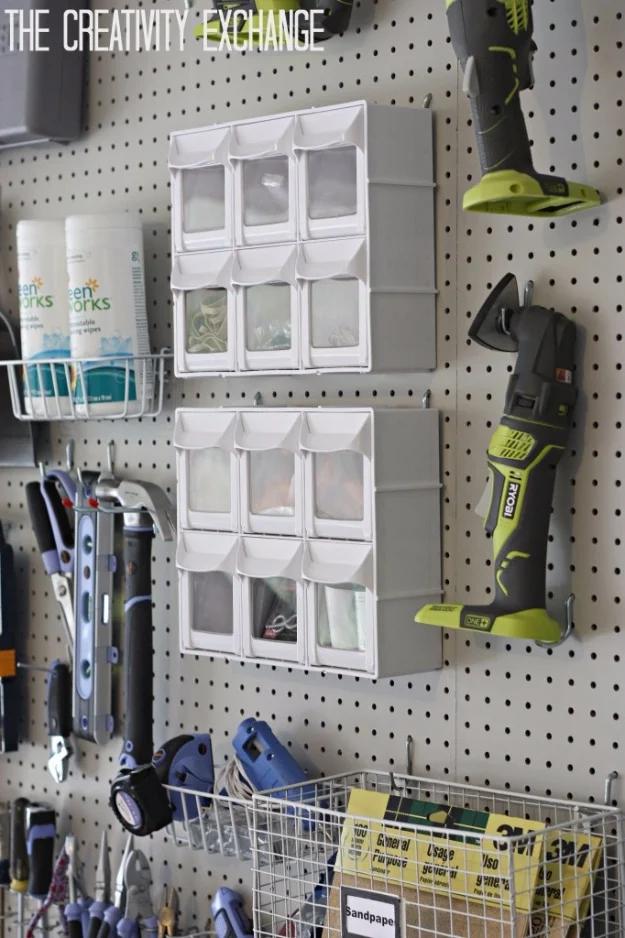 Pegboard wall with white bins, a cordless multi tool, a wire basket, tape measures and a cordless nailer