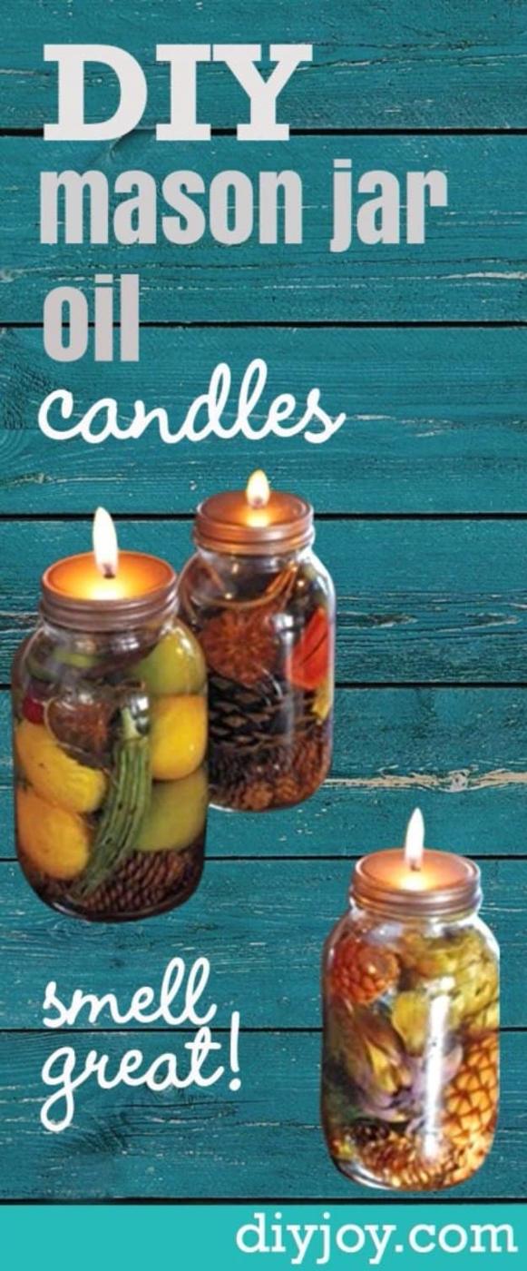 Pin graphic reading DIY mason jar oil candles smell great showing three jars of fruit and coffee beans lit