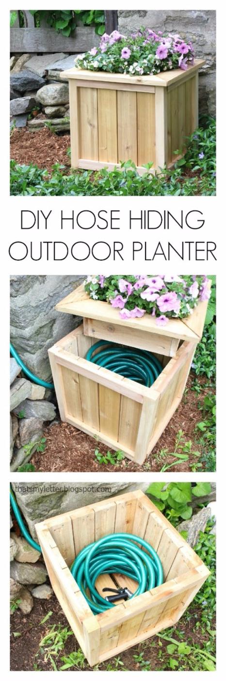 DIY hose hiding planter, a wooden planter box of purple flowers lifted to show a green garden hose coiled inside
