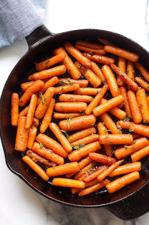 Brown butter garlic honey roasted carrots glazed and browned in a cast iron skillet with fresh thyme