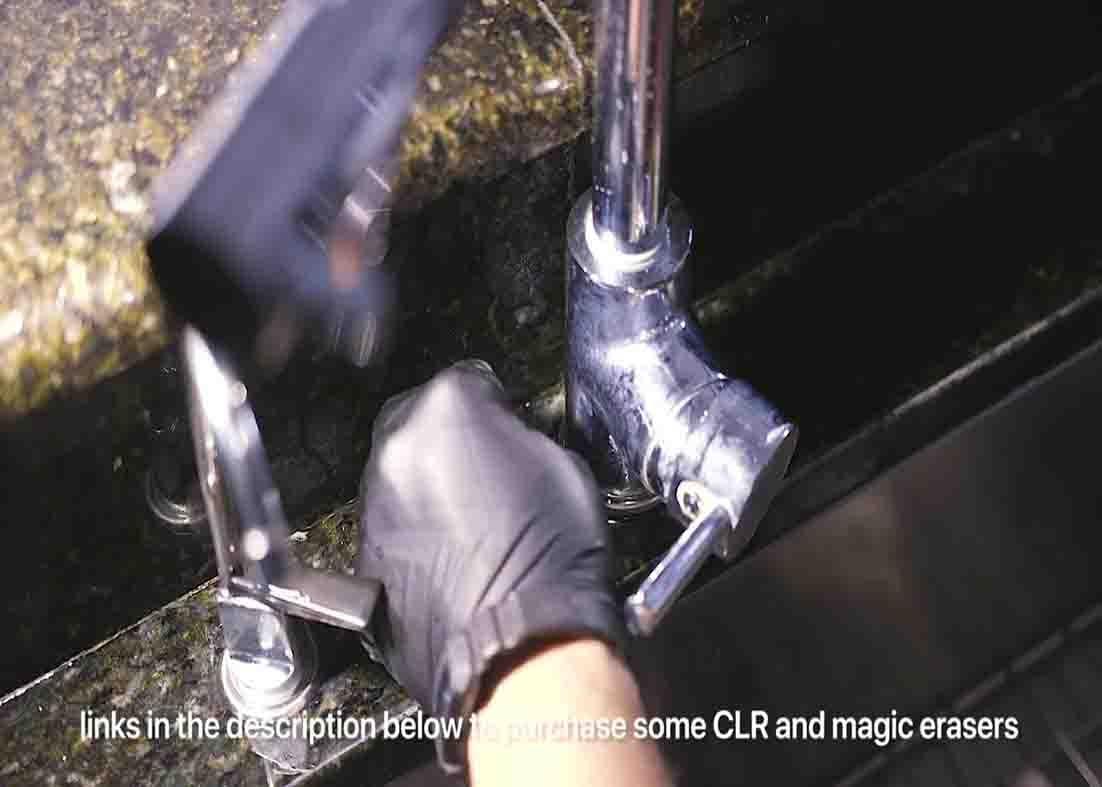 Scraping some leftover water stains using a razor blade