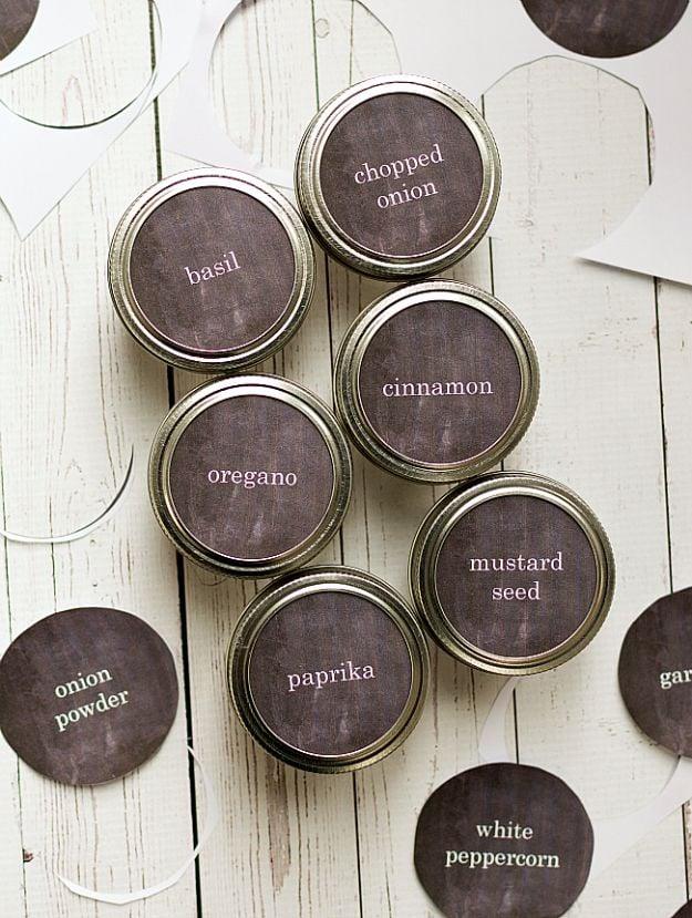 Free printable mason jar spice labels in dark chalkboard style on jar lids reading basil, cinnamon and paprika