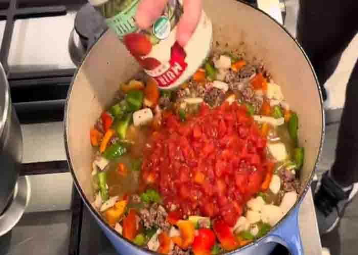 Adding all the ingredients for the one-pot stuffed pepper soup recipe