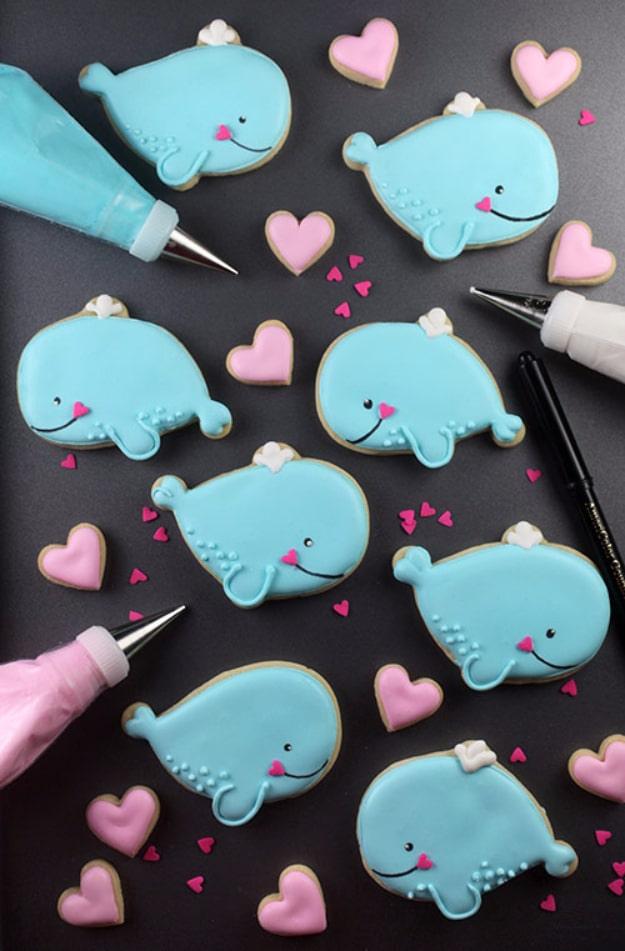 Whale shaped decorated sugar cookies with a punny Valentine message on a cooling rack, a homemade Valentine decorating idea
