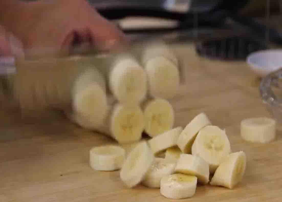 Slicing the banana thinly for the pancake recipe