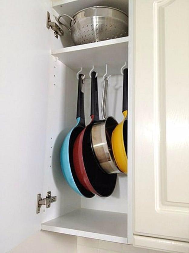 Tension Rods And Shower Hooks As Pot Organizer, simple enough to try with stuff already on hand and the fix worth remembering
