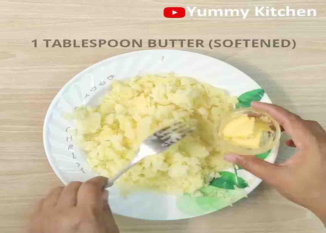Mashing the potatoes for the potato cheese balls recipe