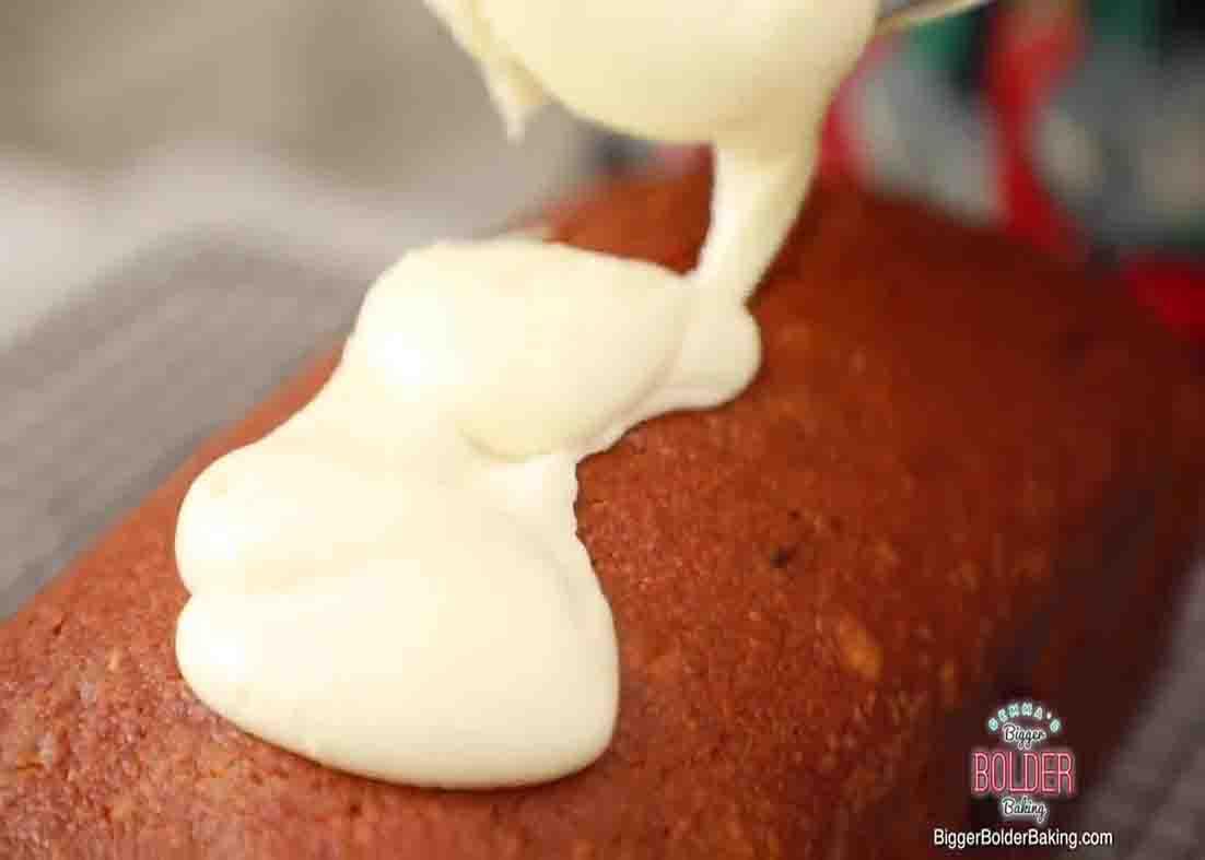 Pouring the glaze over the pumpkin bread