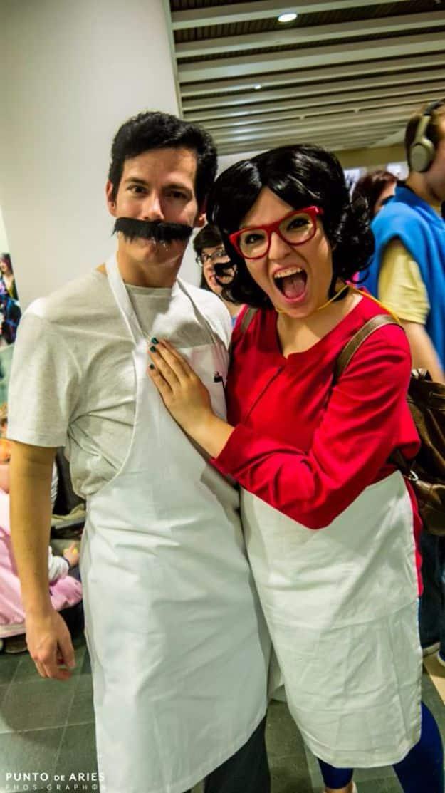 Bob's Burgers couples costume with a black bob wig, red cat eye glasses, white aprons and a fake mustache
