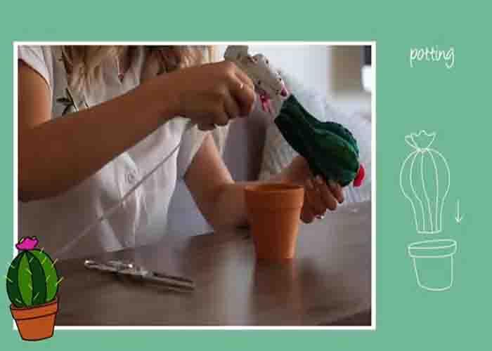 Gluing the cactus pin cushion to the terra cotta pot