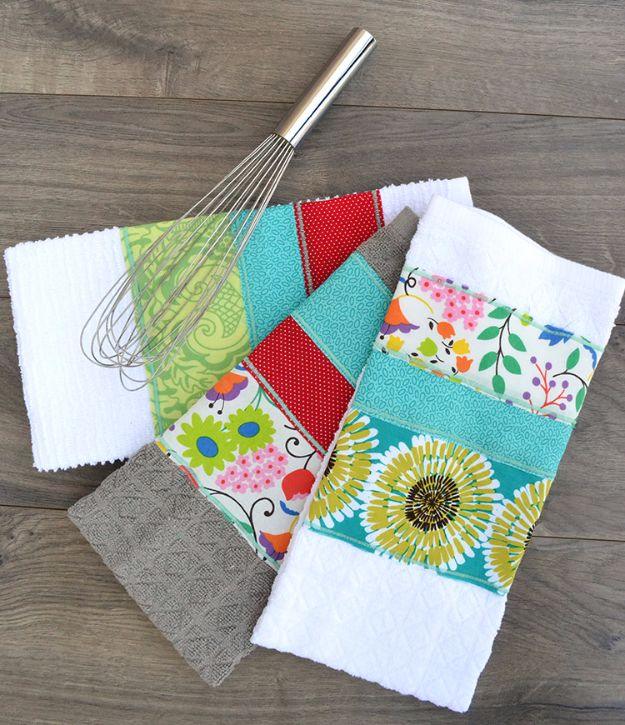 Quilting scraps dish towels with three fabric strips in teal red and floral prints sewn across white terry towels