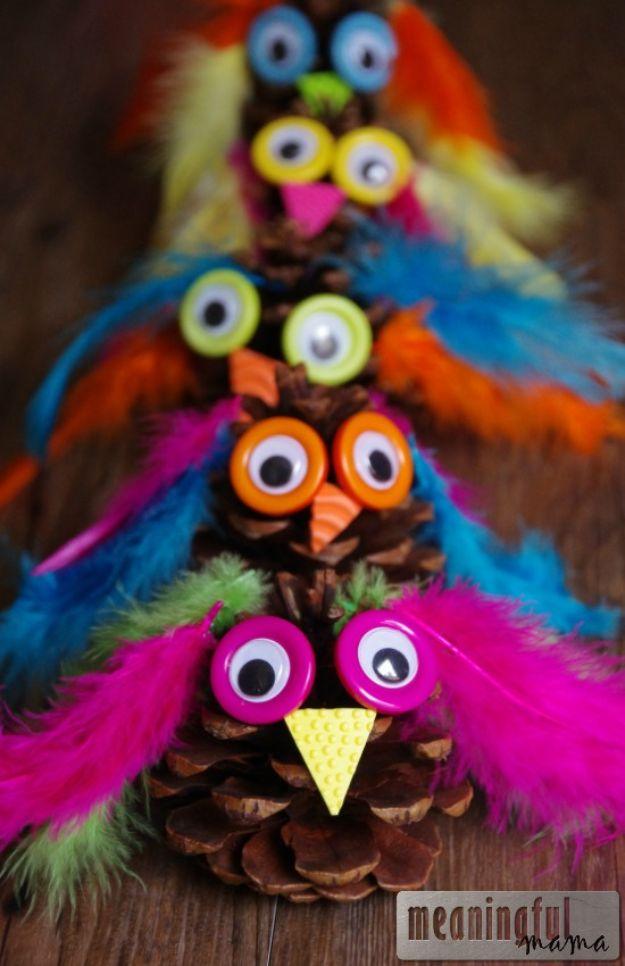 A row of pinecone owls with bright blue, orange and pink feathers, button and googly eyes and foam triangle beaks