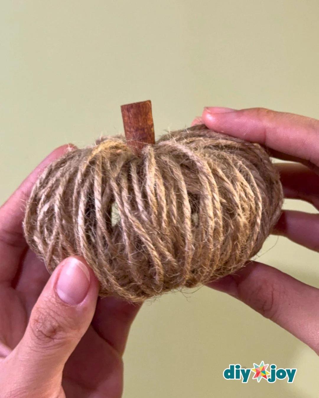 Fall decor ideas - a group of DIY twine pumpkins arranged as a rustic autumn centerpiece that costs almost nothing.