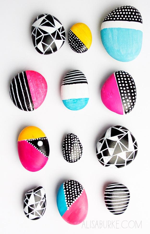 Sharpie rocks, twelve smooth stones painted half plain and half patterned with black, white, pink and teal designs
